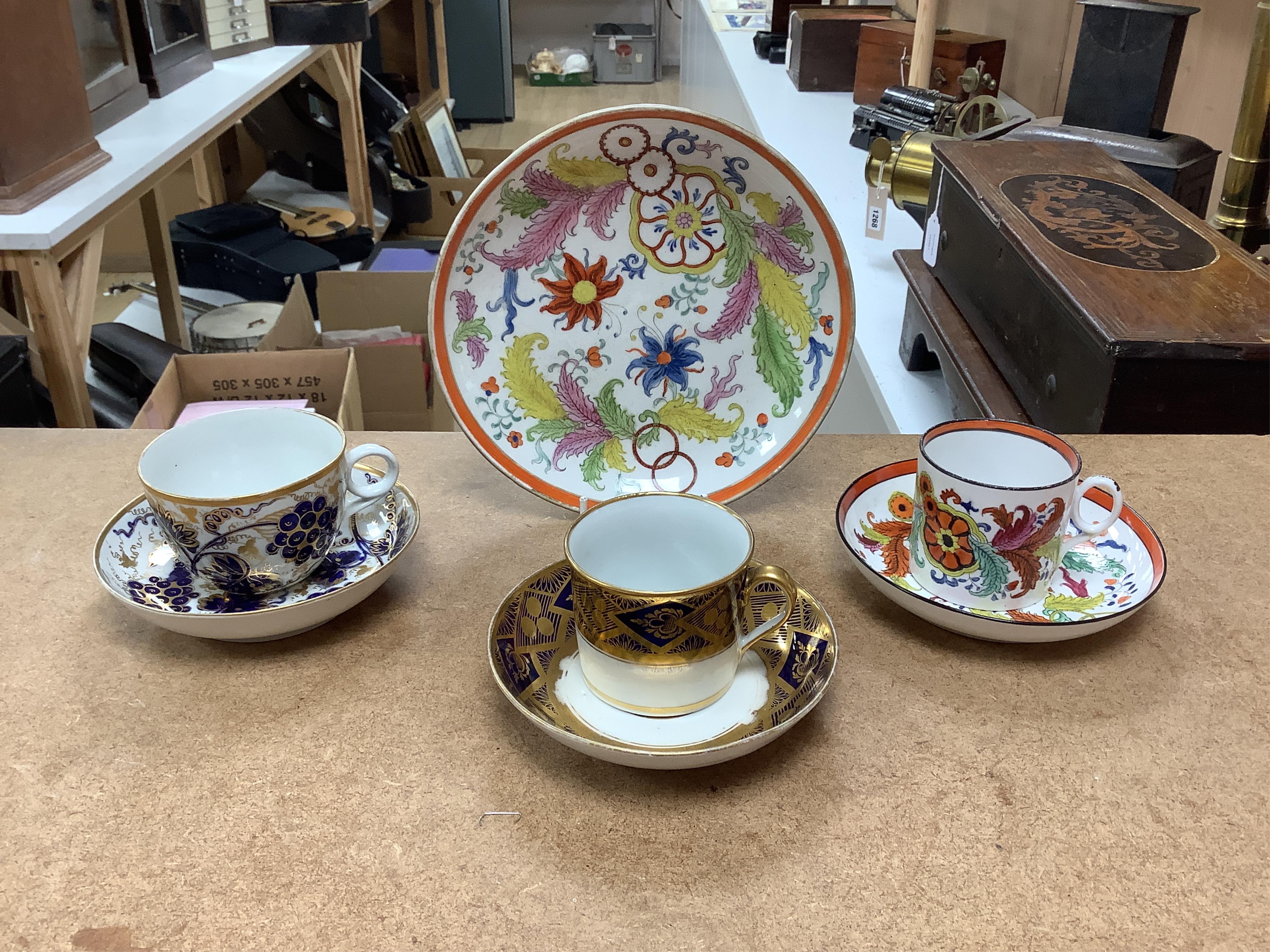 Six mixed English 1800-1820 porcelain cabinet cups and saucers, three similar coffee cans and saucers, a matching spoon stand and two coffee cans, a saucer dish, coffee can plus saucer and a tea bowl and matching saucer